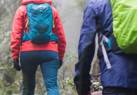 Two people walking with Hiking Backpacks.